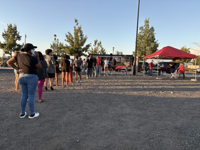 A line of customers waiting at the CoquiEats truck