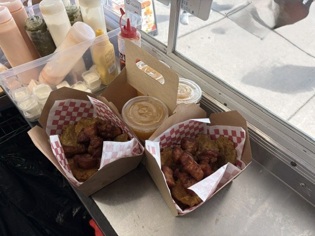 Two boxes of freshly fried Puerto Rican frituras with dipping sauce