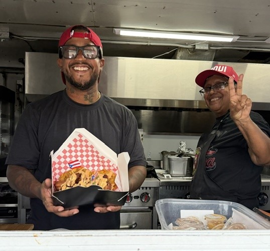 Alex and his mom serving a fresh order from the CoquiEats truck window